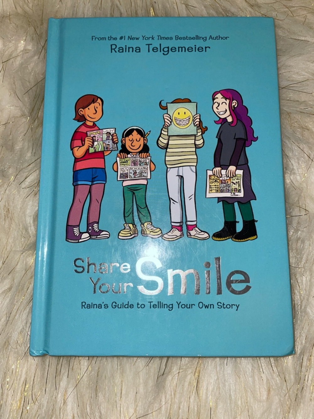 Share Your Smile by Raina Telgemeier - Blue Hardcover Graphic Guide